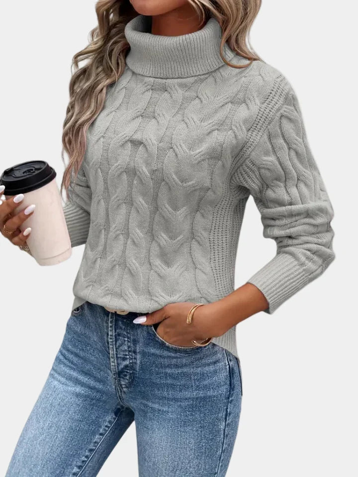 Cora Women’s Sweater featuring a stylish cable knit design and a cozy high turtleneck collar, perfect for fall and winter layering. 6