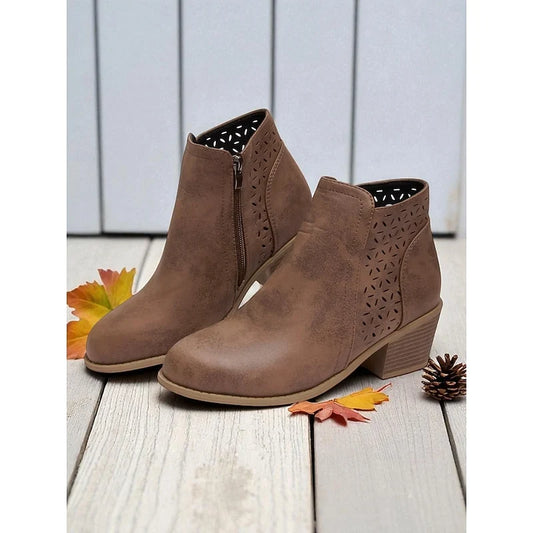 Haven Women's ankle boots featuring a stylish low block heel and elegant cutout detail, perfect for fashionable fall and winter outfits. 0