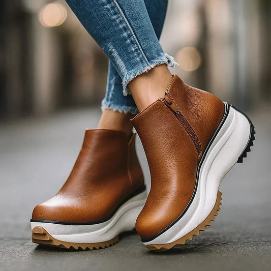 Luxe women’s ankle boots featuring a stylish side-zip design, comfortable wedge heel, and durable lug sole, perfect for fashionable and functional wear. 0