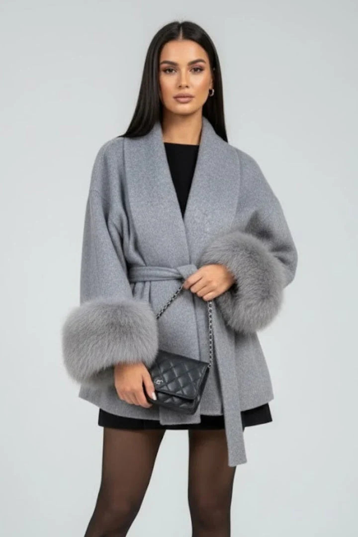 Willa Women's full-length coat featuring a stylish waist tie and elegant faux fur cuffs, perfect for winter fashion and warmth. 1