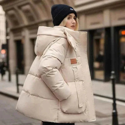 Wren Women's Winter Coat featuring a stylish funnel neck and padded insulation for warmth and comfort during cold weather. 1